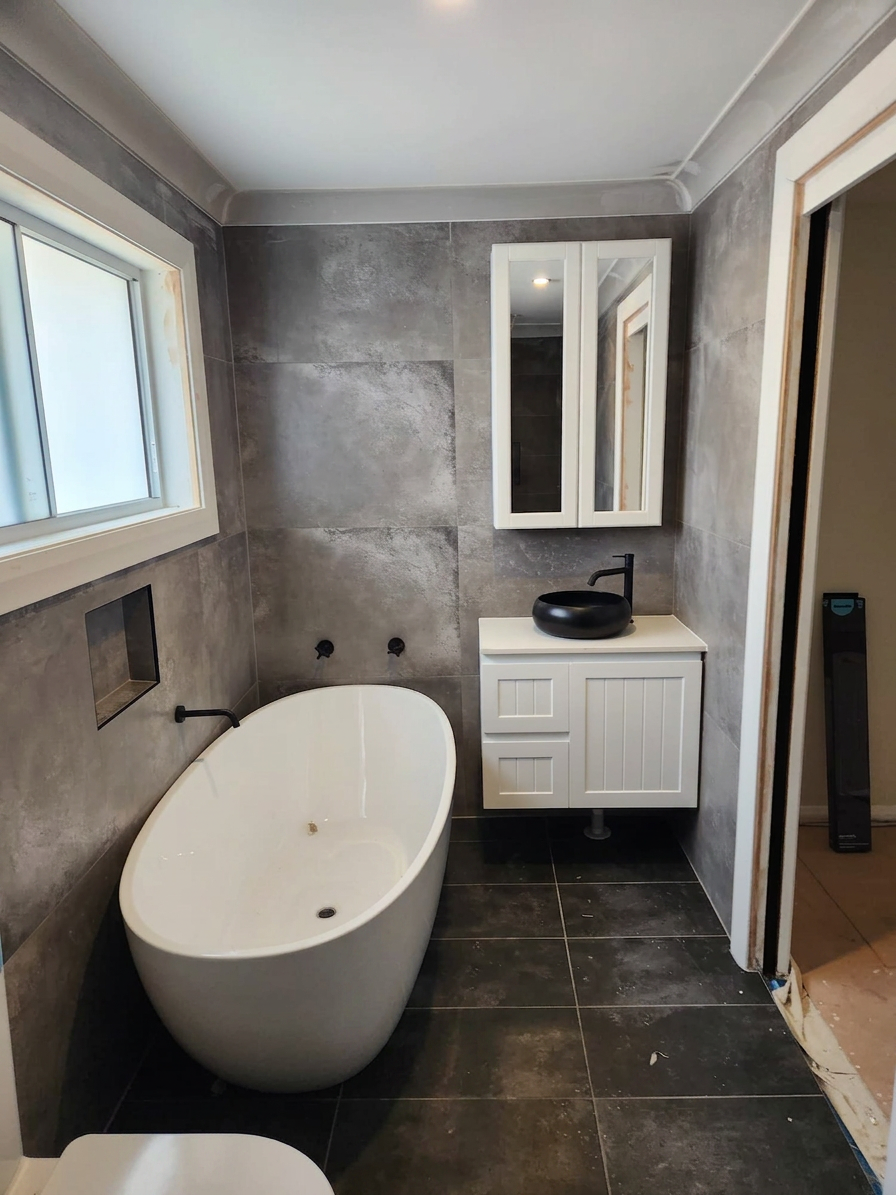 Sydney bathroom renovation with concrete-look tiles and freestanding bath