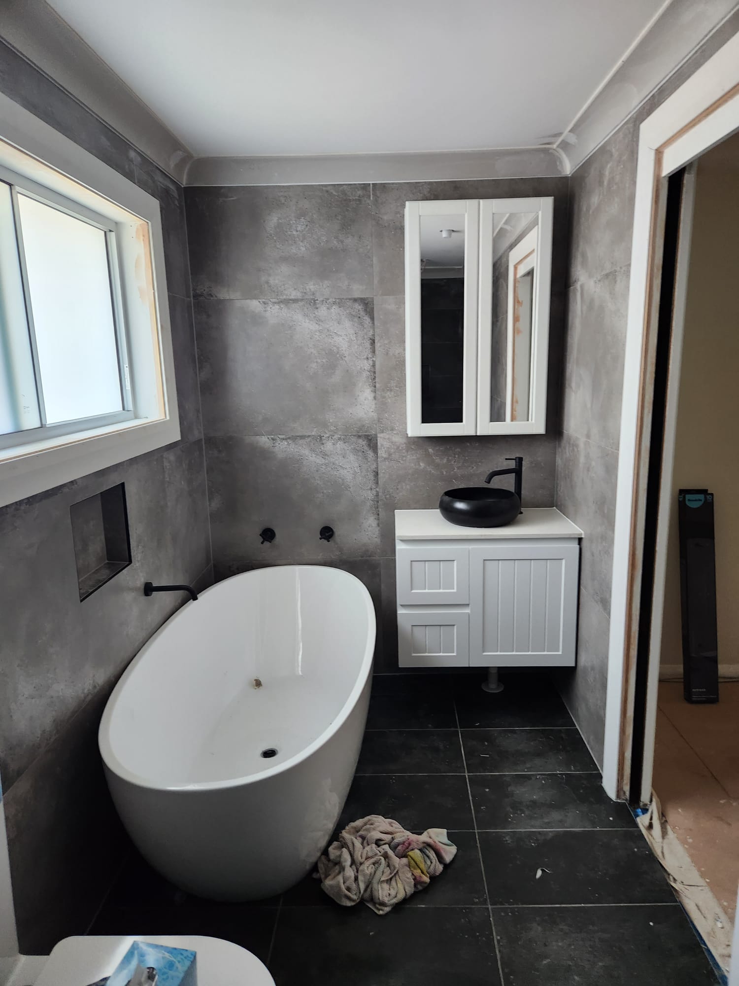 Sydney bathroom renovation with concrete-look tiles and freestanding bath